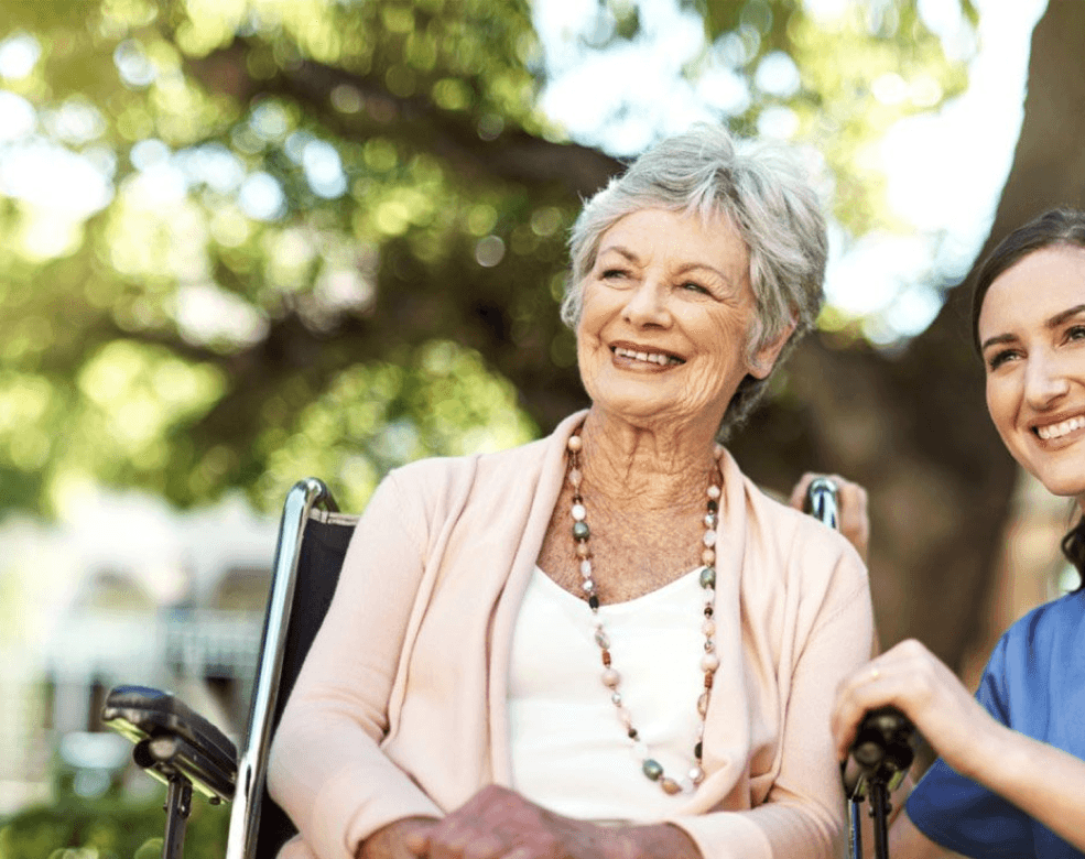 Image of a nurse embracing an elderly woman