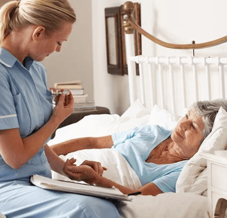 Image of a nurse embracing an elderly woman